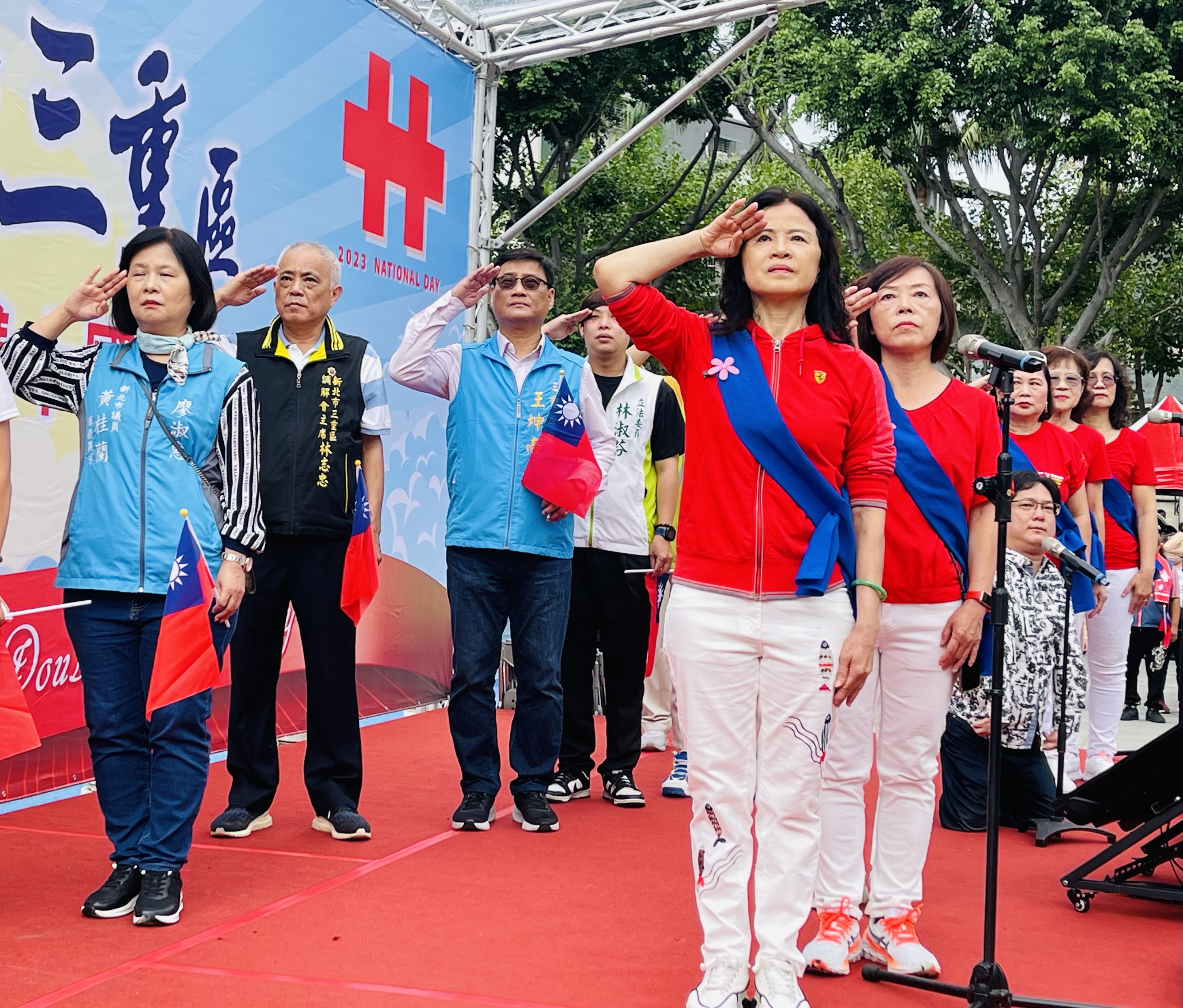 三重國慶升旗慶典，由「生命鬥士–王奇男」先生及三重寶貝志工合唱團共同領唱國歌。
